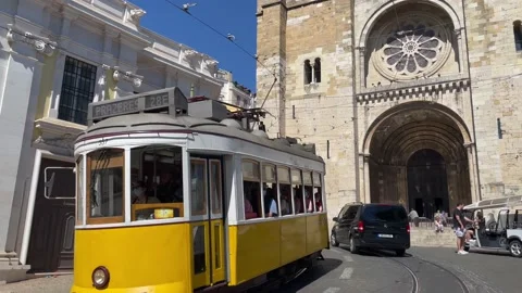 Lisbon Tram 28 passing in front of the Cathedral (Se) in Lisbon Video stock 197508741