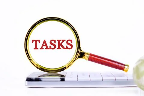 List and Schedule concept. TASK business word through the lens of a magnifyin Stock Photos