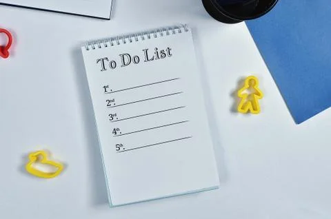 List to do, white notebook, blue paper, pen and pencil case, on white paper b Stock Photos