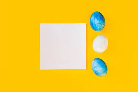 List or note isolated with set of colorful eggs. Spring trendy composition on Stock Photos