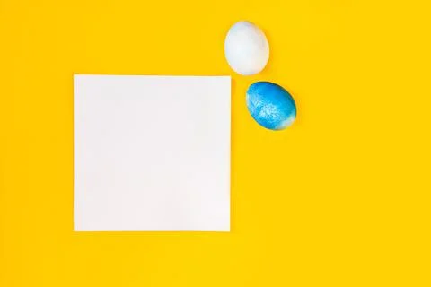 List or note isolated with set of colorful eggs. Spring trendy composition on Photos