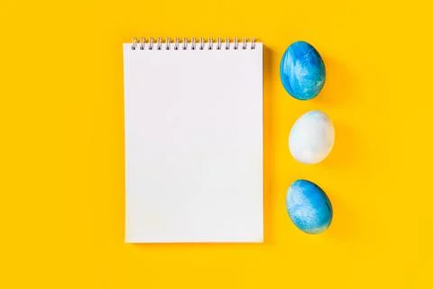 List or note isolated with set of colorful eggs. Spring trendy composition on Stock Photos