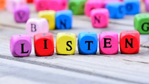 Listen word on table Stock Photos