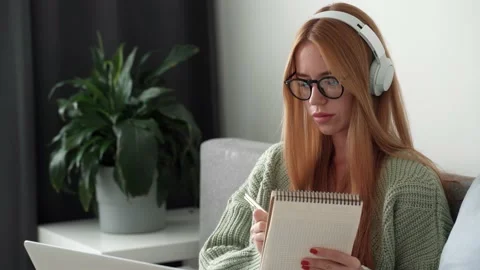 Listening and taking notes in notepad at home Stock Footage 170033955