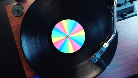 Listening Playback of Long Play Vinyl Record With Rainbow Sticker, Top Down View Stock Footage 334833055