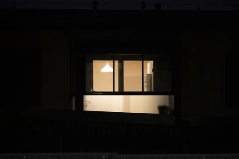 Lit apartment window at night Stock Photos