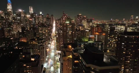 Lit avenue cutting through Manhattan after nightfall Stock Footage 230311038