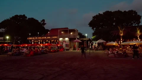 Lit beachfront cafes at twilight , Seminyak Beach, Bali 動画素材 336514902