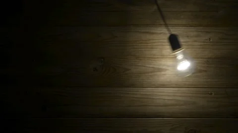 Lit bulb swinging Stock Footage 44637883