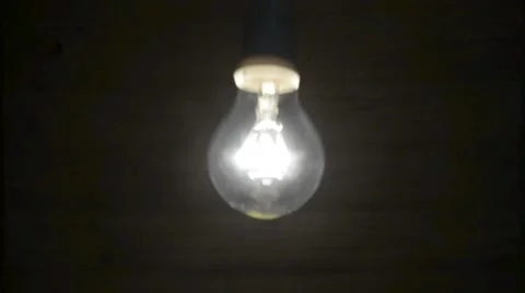 Lit bulb swinging Stock Footage 44637884