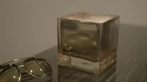 Lit Candle and Sunglasses on Table in Apartment Stock Footage 344604211