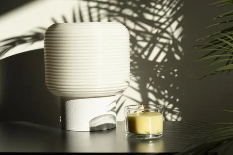 Lit Candle and Table Lamp in Sunlit Interior Foto stock