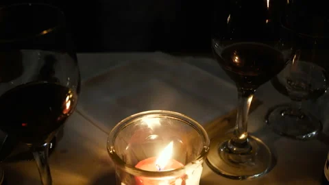 Lit candle and two glasses of wine Stock Footage 104130467