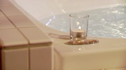 Lit candle on bathtub Stock Footage 55333482
