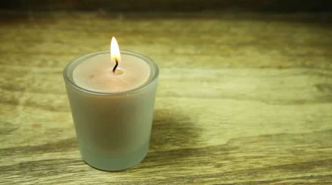 Lit candle being turned off by blowing into it, with copy space on the right Stock Footage 22322873