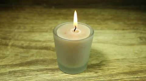Lit candle being turned off by blowing into it, with candle in the middle Stock Footage 22322930