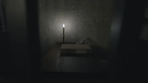 Lit Candle Beside Book in Dark Chapel Interior Stock Footage 341343603