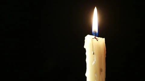 Lit candle on a black background close-up trembling in the wind Stock Footage 106526306