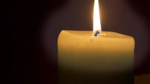 A lit candle on a black background 스톡 동영상 220304968
