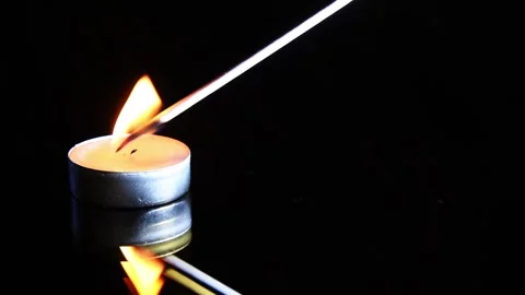 Lit candle on black background. Minimalism. Stock Footage 167948831