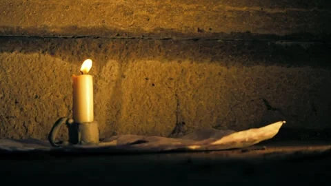 Lit Candle in candlestick holder Stock Footage 296154156
