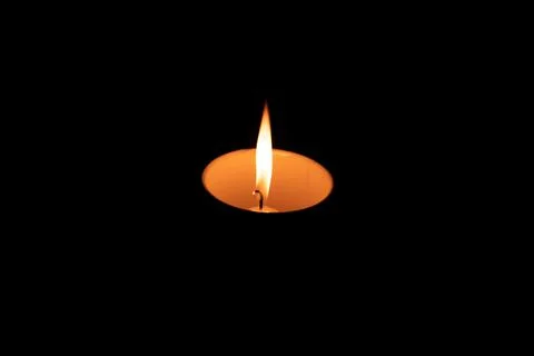Lit candle in a cup Foto stock