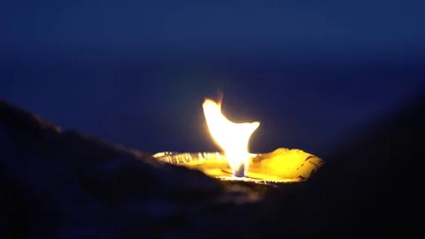 Lit candle at the ocean in the evening Video stock 80134080