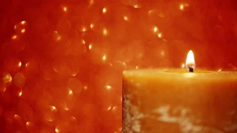 Lit candle on a red shimmering background Video stock 144795101