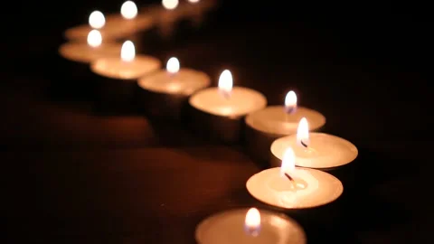 Lit candles in a row at night Stock Footage 108067038