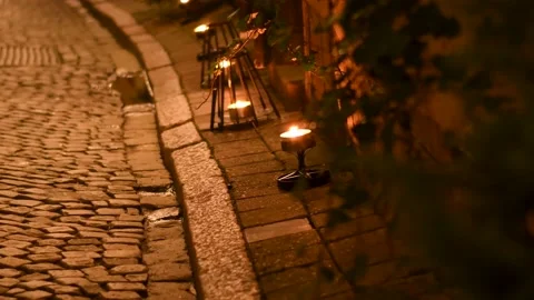 Lit candles on the sidewalk in the city Stock Footage 145275397