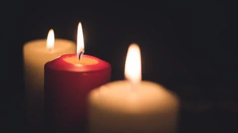A lit candles on a table in a dining room Stock Photos