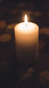 A lit candles on a table in a dining room Stock Photos