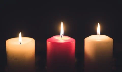 A lit candles on a table in a dining room Stock Photos