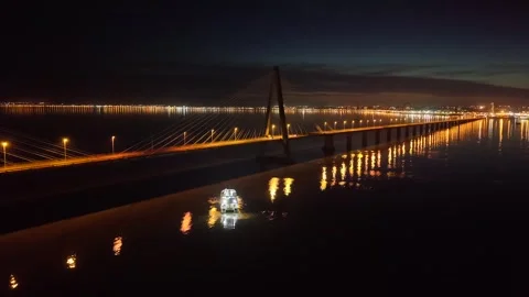 Lit catamaran navigates dark waters of Paraná River beneath the illuminated Stock-Footage 323809210