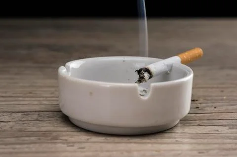 Lit cigarette in ashtray Stock Photos