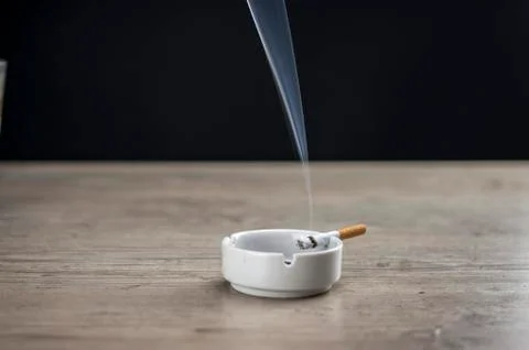 Lit cigarette in ashtray Stock Photos