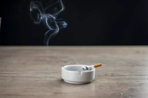 Lit cigarette in ashtray Stock Photos