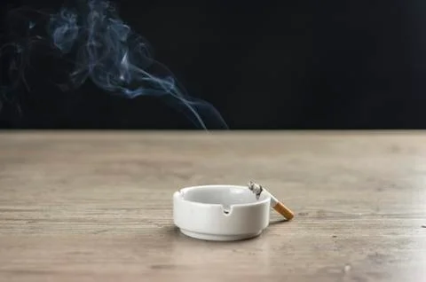 Lit cigarette in ashtray Stock Photos