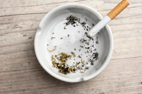 Lit cigarette in ashtray Stock Photos