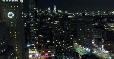 Lit clock face and Flatiron district rooftops after nightfall Vídeo Stock 76969020