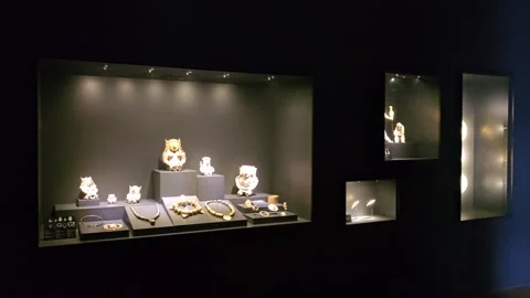 Lit Display Case of Clay Masks and Gold Ornaments, Casa del Alabado, Ecuador 8K Video stock 331492930