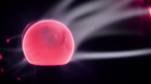 Lit eletric tesla coil ball, with blue energy light rays moving Stock Footage 78832353