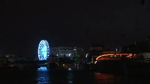 Lit up Ferris Wheel on coast Stock Footage 8912205