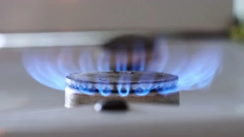 Lit flame of kitchen stove burner close-up Stock Footage 201192825