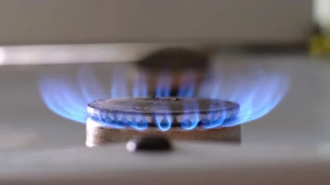 Lit flame of kitchen stove burner close-up Stock Footage 202276112