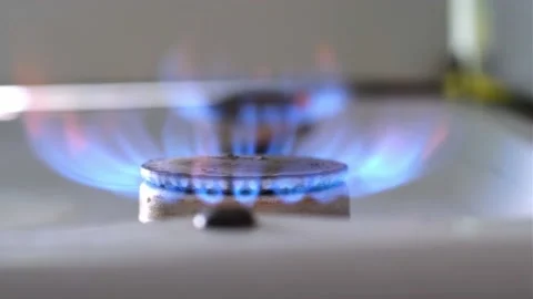 Lit flame of kitchen stove burner close-up Stock Footage 202276118