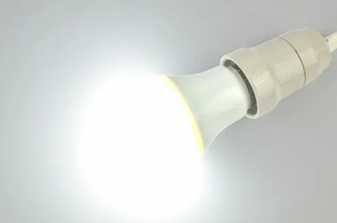 Lit LED light bulb on white Stock Photos