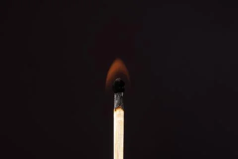 A lit match on a dark background. Macro photography. Flame. Foto stock