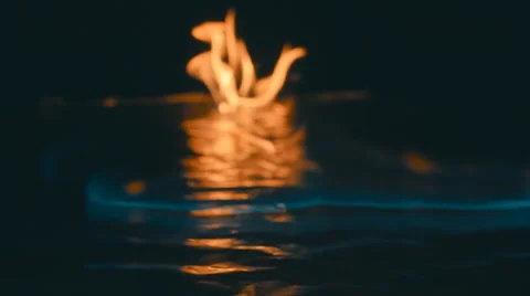 A lit match ignites gasoline. Blue Wave at the forefront of fire go to meet Stock Footage
