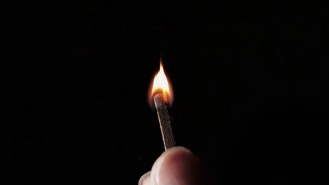 Lit match stick held in fingers burns in 2x slow motion close up isolated Stock Footage 117288858